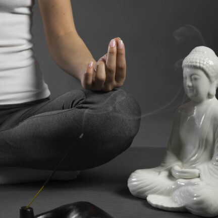 person-meditating-buddha-statuette